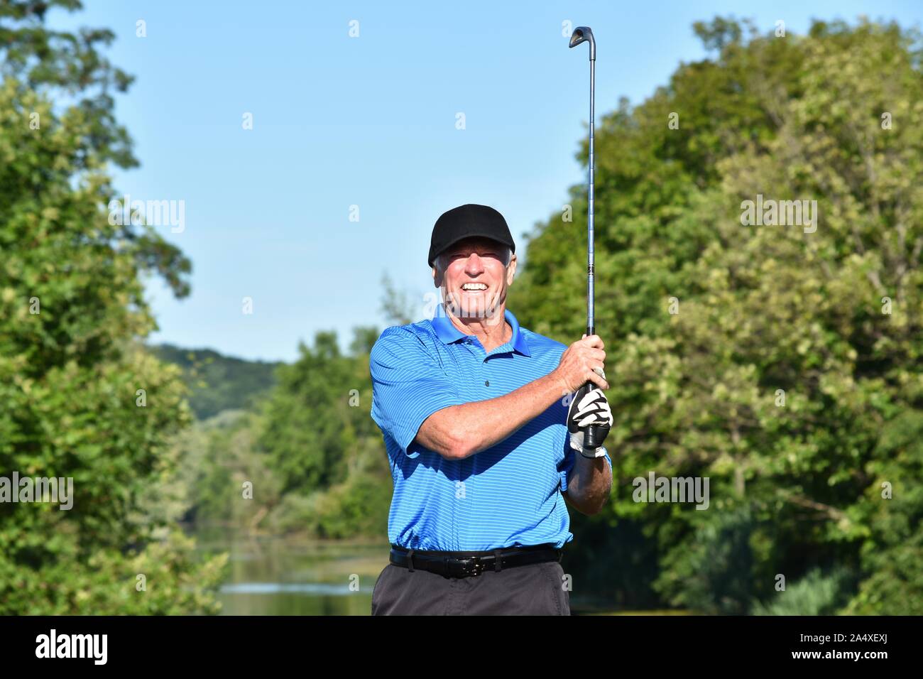 Adult Male Athlete Outdoors With Golf Club Playing Golf Stock Photo