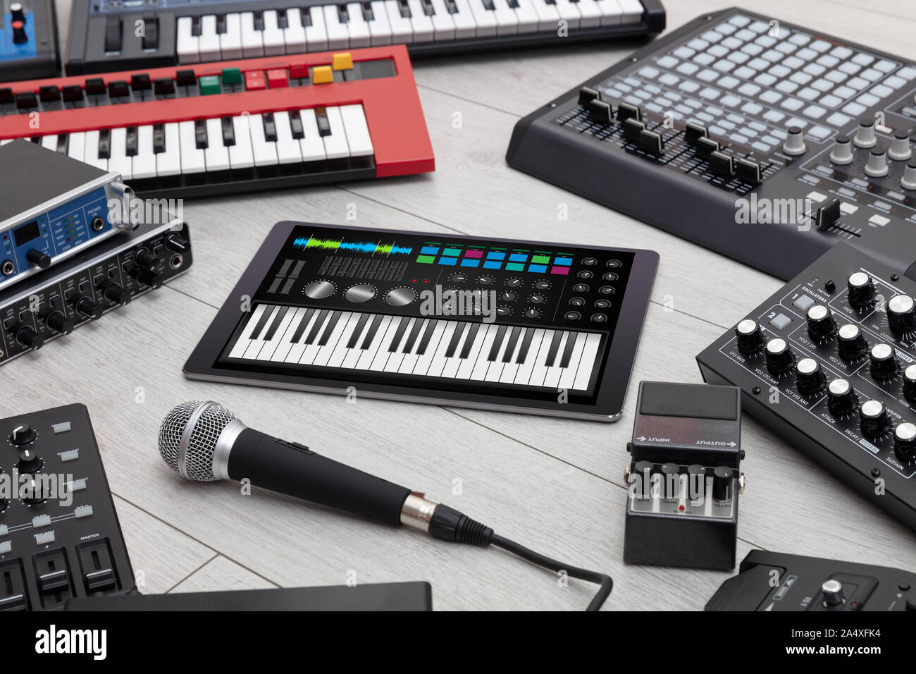 Piano synthesizer app on tablet and musical instrument concept Stock