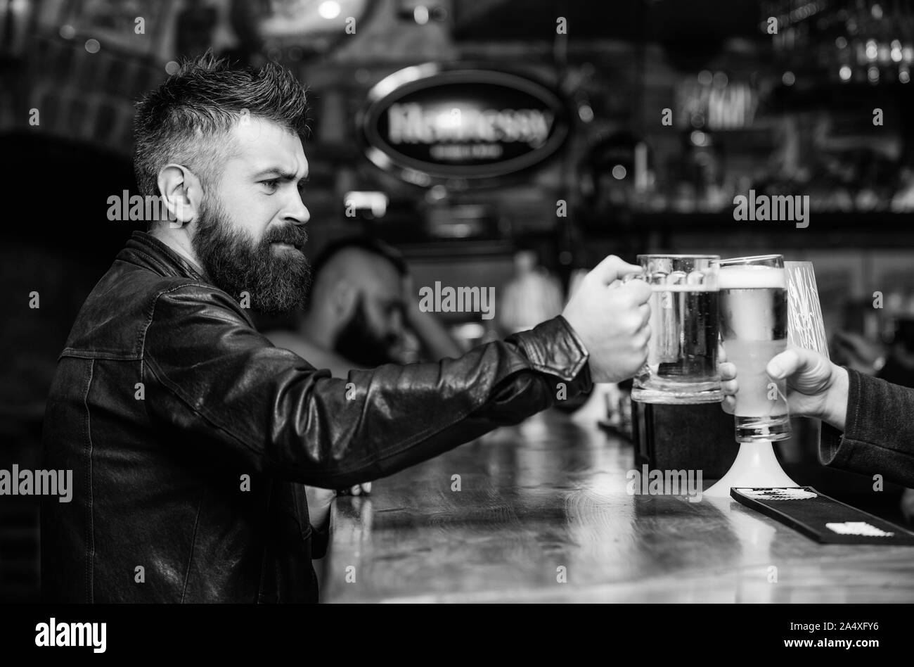 Cheers concept. Men hipster hold mugs filled with cold tasty beer in
