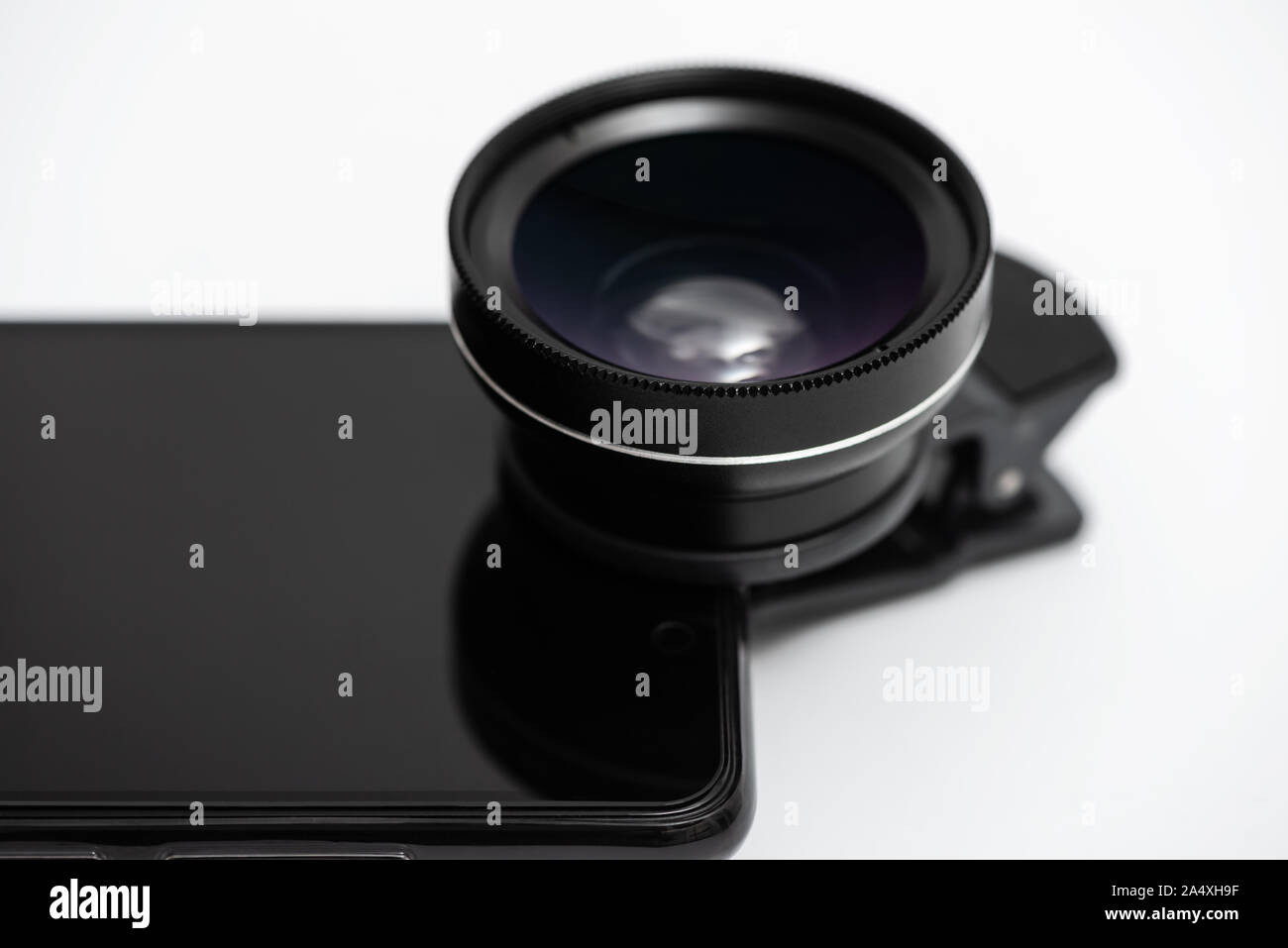 Macro lens is attached to the smartphone camera. Stock Photo