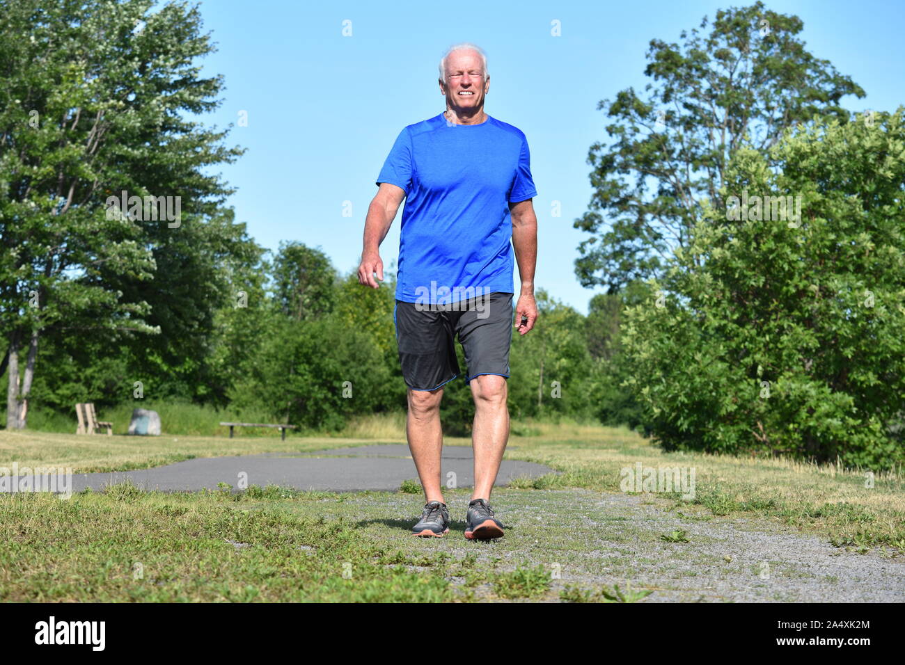 Old Male Senior Smiling Wearing Sneakers Exercising Stock Photo