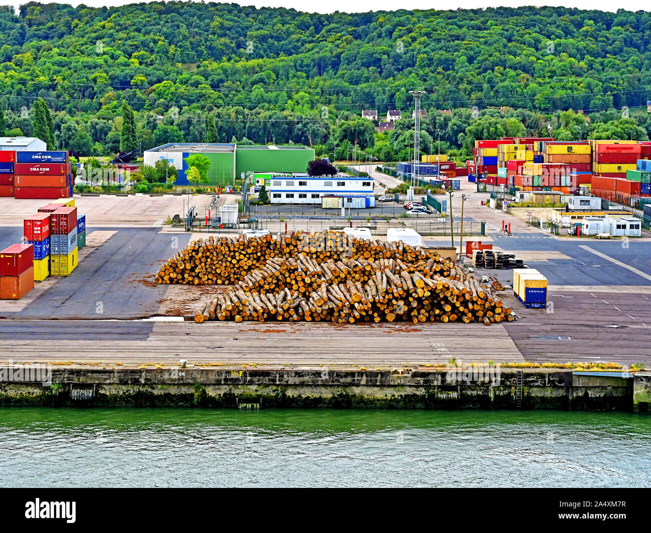 River Seine La Havre area Rouen August 14 2019  Container loading site alongside timber waiting at the dockside Stock Photo