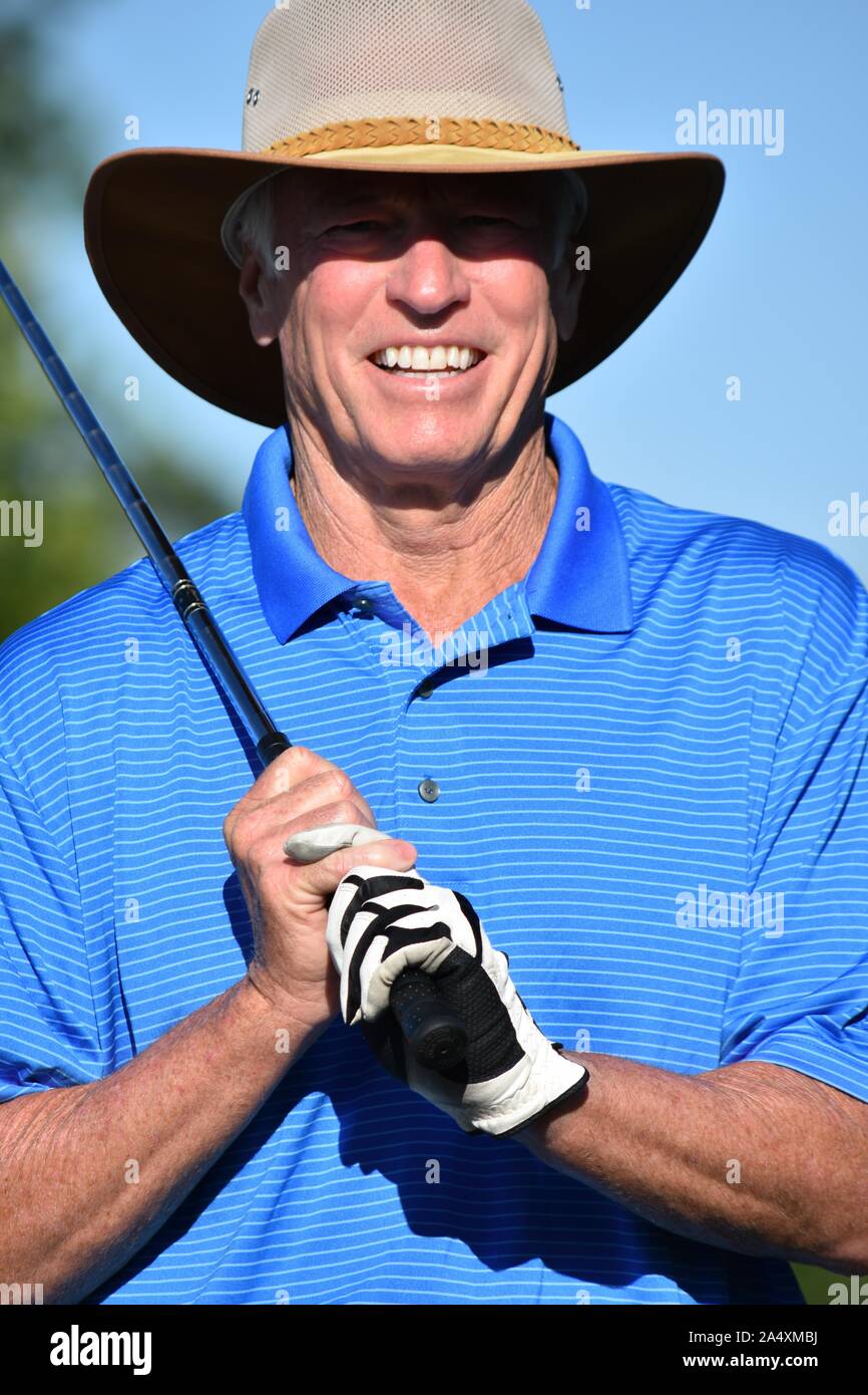 Fitness Retiree Male Golfer Smiling With Golf Club Playing Golf Stock Photo