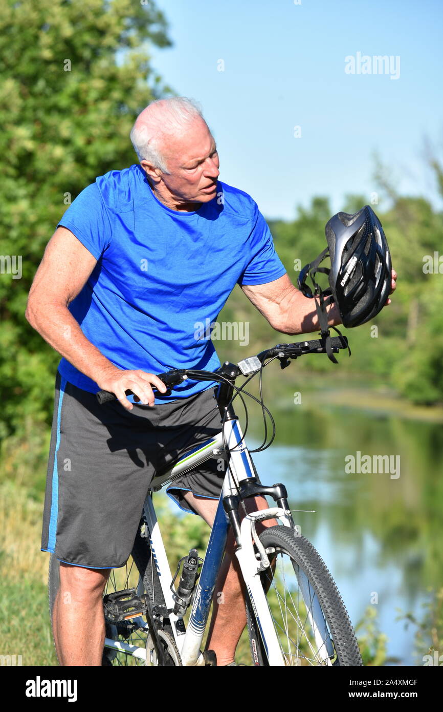 Old man wearing helmet riding hi-res stock photography and images - Alamy