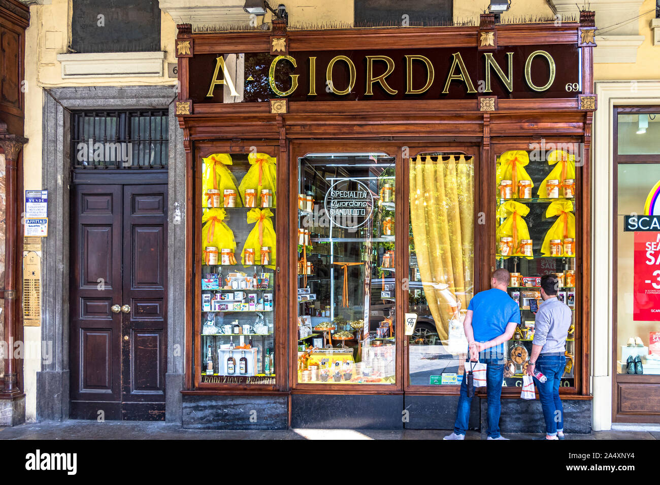 People outside A. Giordano chocolate shop under the porticoes in Turin’s Piazza Carlo Felice A. Giordano chocolate company was established in 1897 Stock Photo