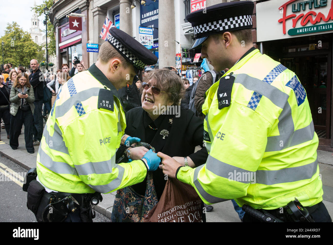 London, UK. 16 October, 2019. Police officers arrest a climate activist from Extinction Rebellion who had defied the Metropolitan Police prohibition on Extinction Rebellion Autumn Uprising protests throughout London under Section 14 of the Public Order Act 1986 by sitting in the road in Whitehall. Credit: Mark Kerrison/Alamy Live News Stock Photo