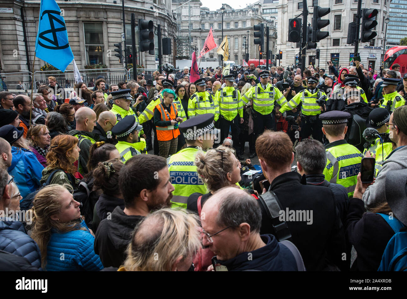 London, UK. 16 October, 2019. Police officers arrest climate activists from Extinction Rebellion who had defied the Metropolitan Police prohibition on Extinction Rebellion Autumn Uprising protests throughout London under Section 14 of the Public Order Act 1986 by sitting in the road in Whitehall. Credit: Mark Kerrison/Alamy Live News Stock Photo