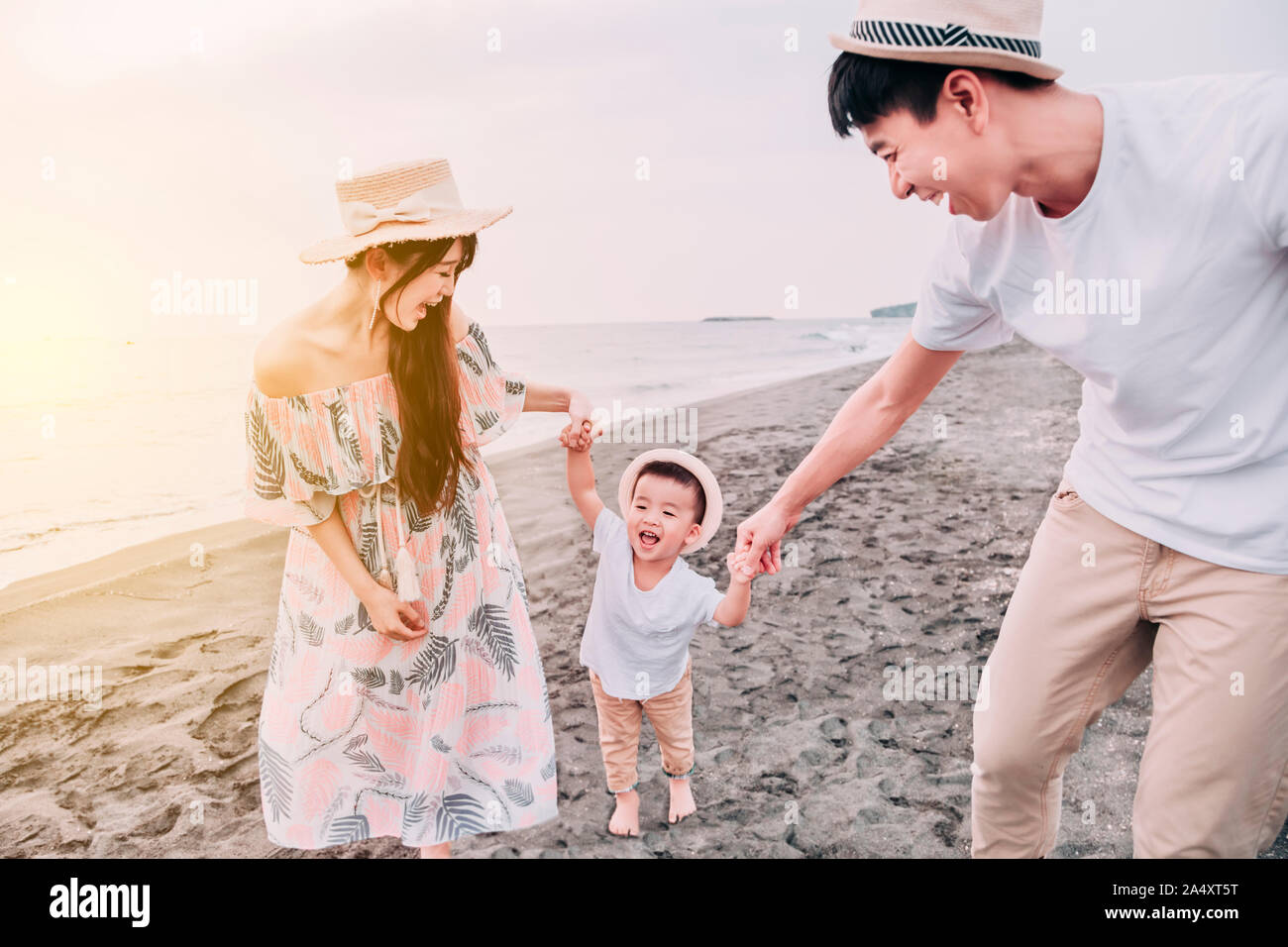 Young asian family on the beach hi-res stock photography and images - Alamy