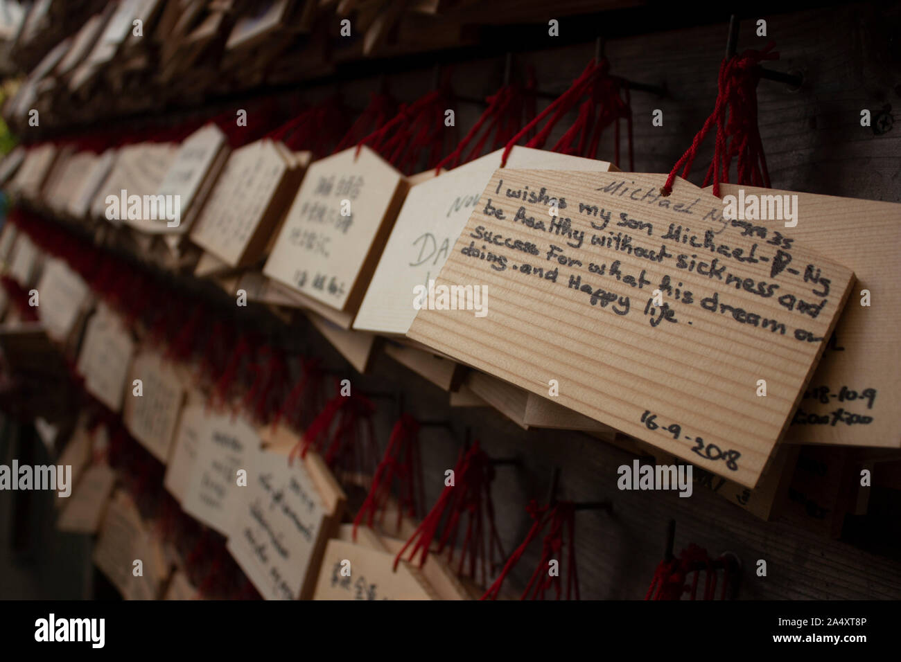 Wishes that people written on wood hang waiting for tradition to be fulfilled in Buddhist temples. Stock Photo