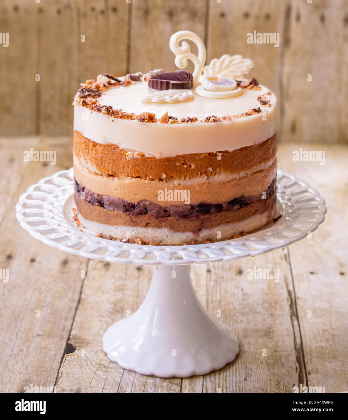 Layered piecaken dessert on stand- pumpkin pie, caramel and milk mousse Stock Photo