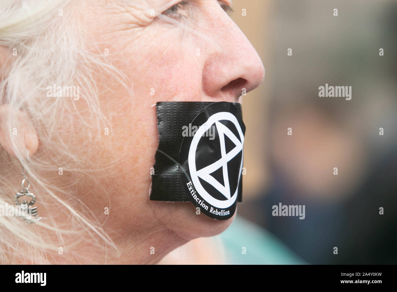 London, UK. 16th Oct, 2019. A Climate activist from Extinction rebellion stage tapes her mouth during a protest vigil in Trafalgar Square to oppose section 14 of the public order act 1986 imposed by the Police which bans protests. Credit: SOPA Images Limited/Alamy Live News Stock Photo
