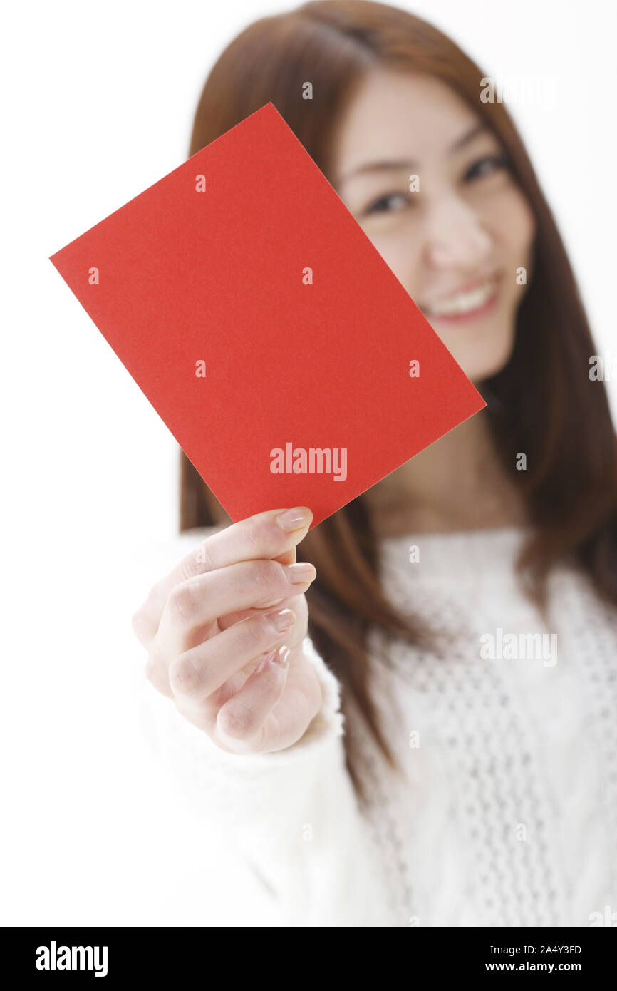 a smiling young woman holding red card Stock Photo