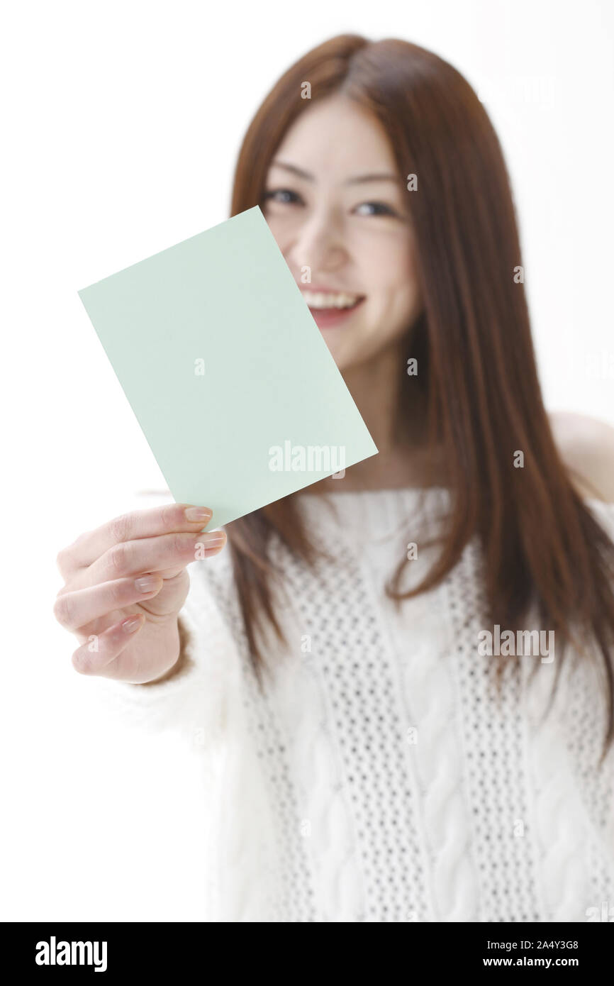 A young woman showing blue card Stock Photo