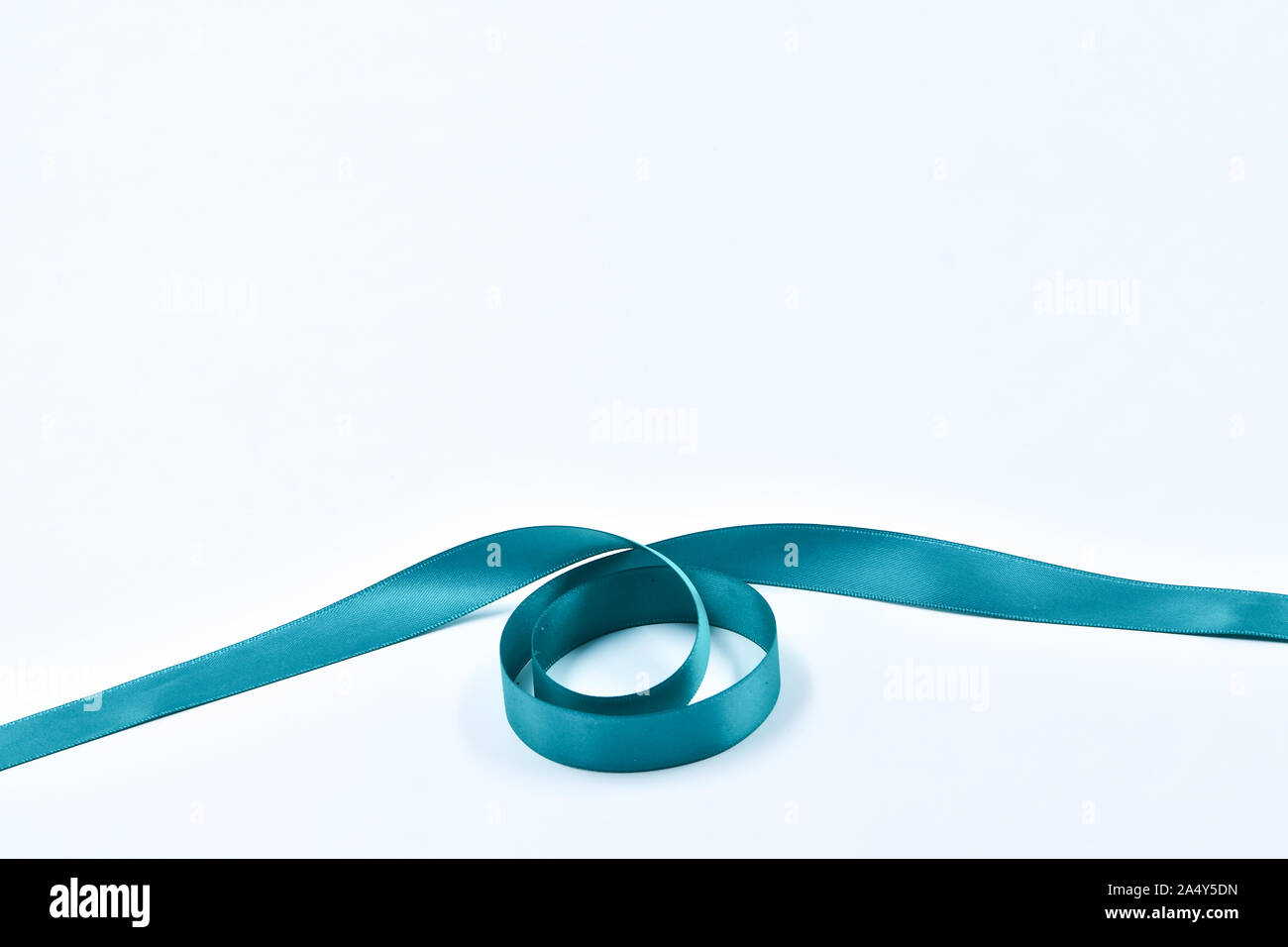 Aquamarine curly ribbon on white background, decorative elements Stock Photo