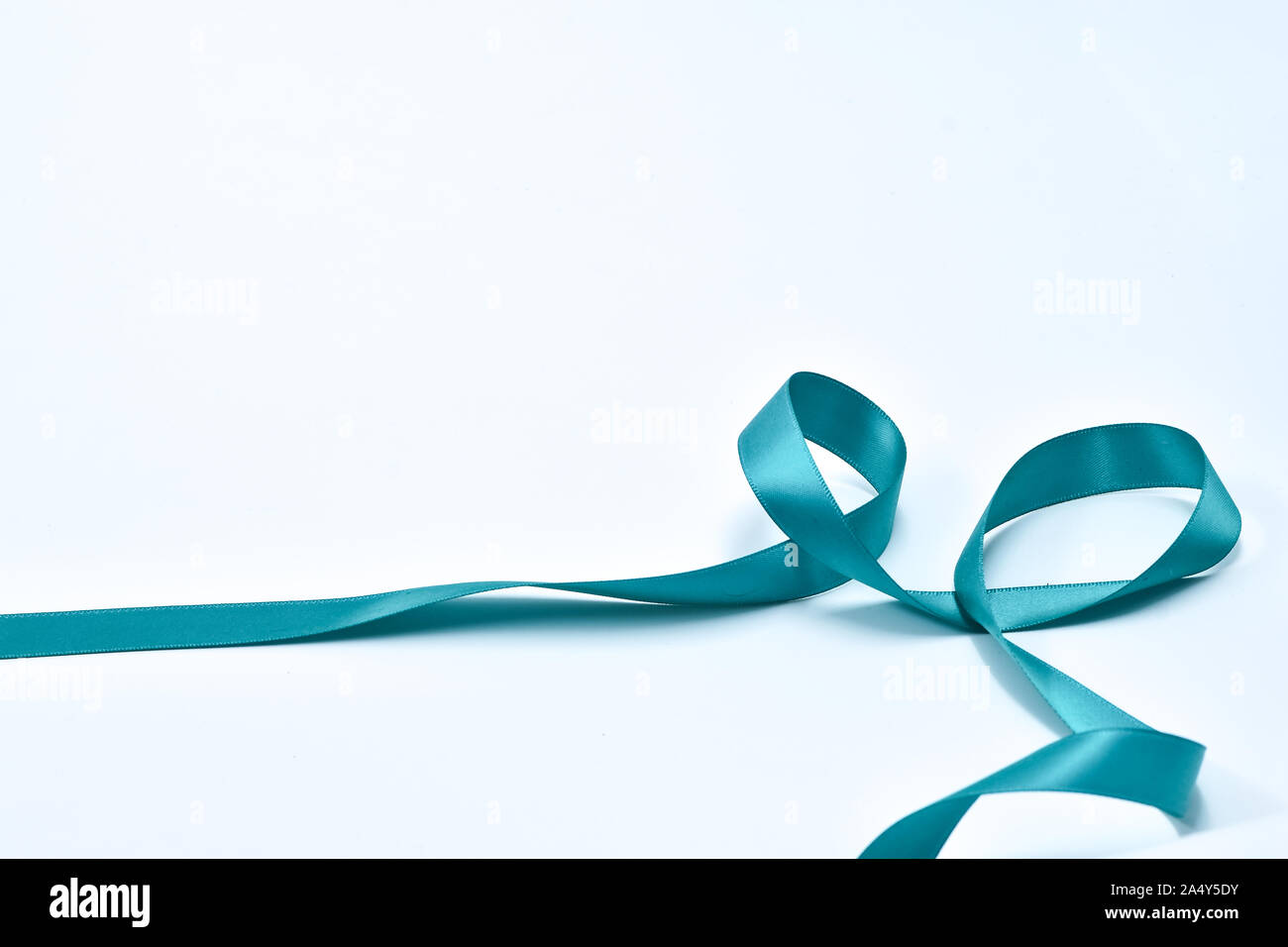 Aquamarine curly ribbon on white background, decorative elements Stock Photo
