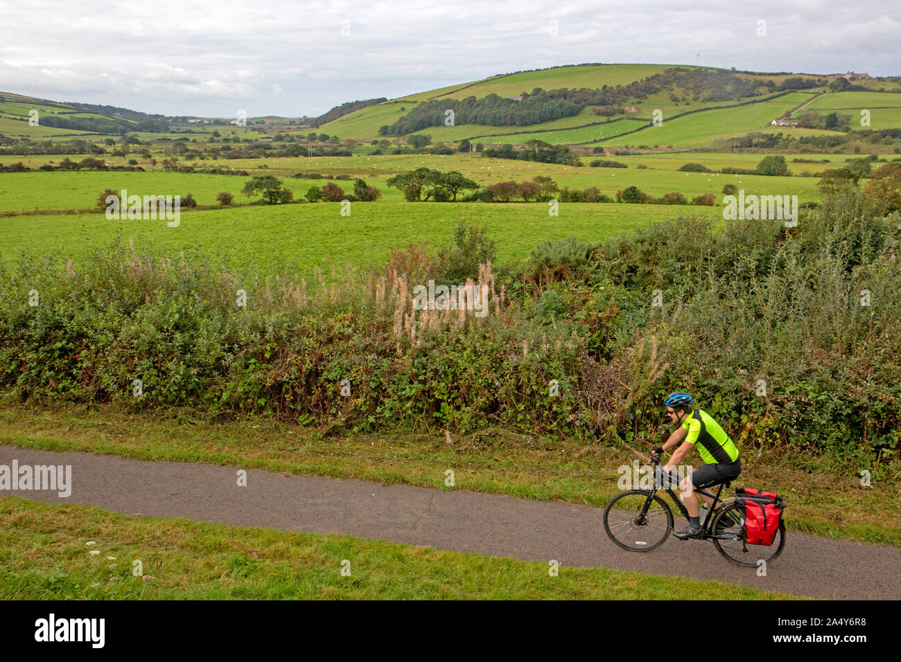 Cyclist on the disused Ennerdale Railway track, part of the Coast to Coast cycle route Stock Photo