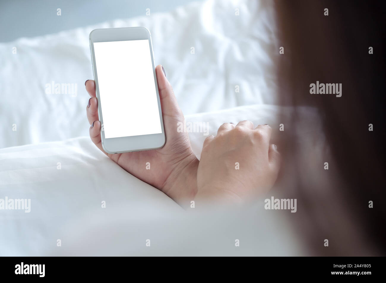 Mockup image of a woman's hand holding white mobile phone with blank ...