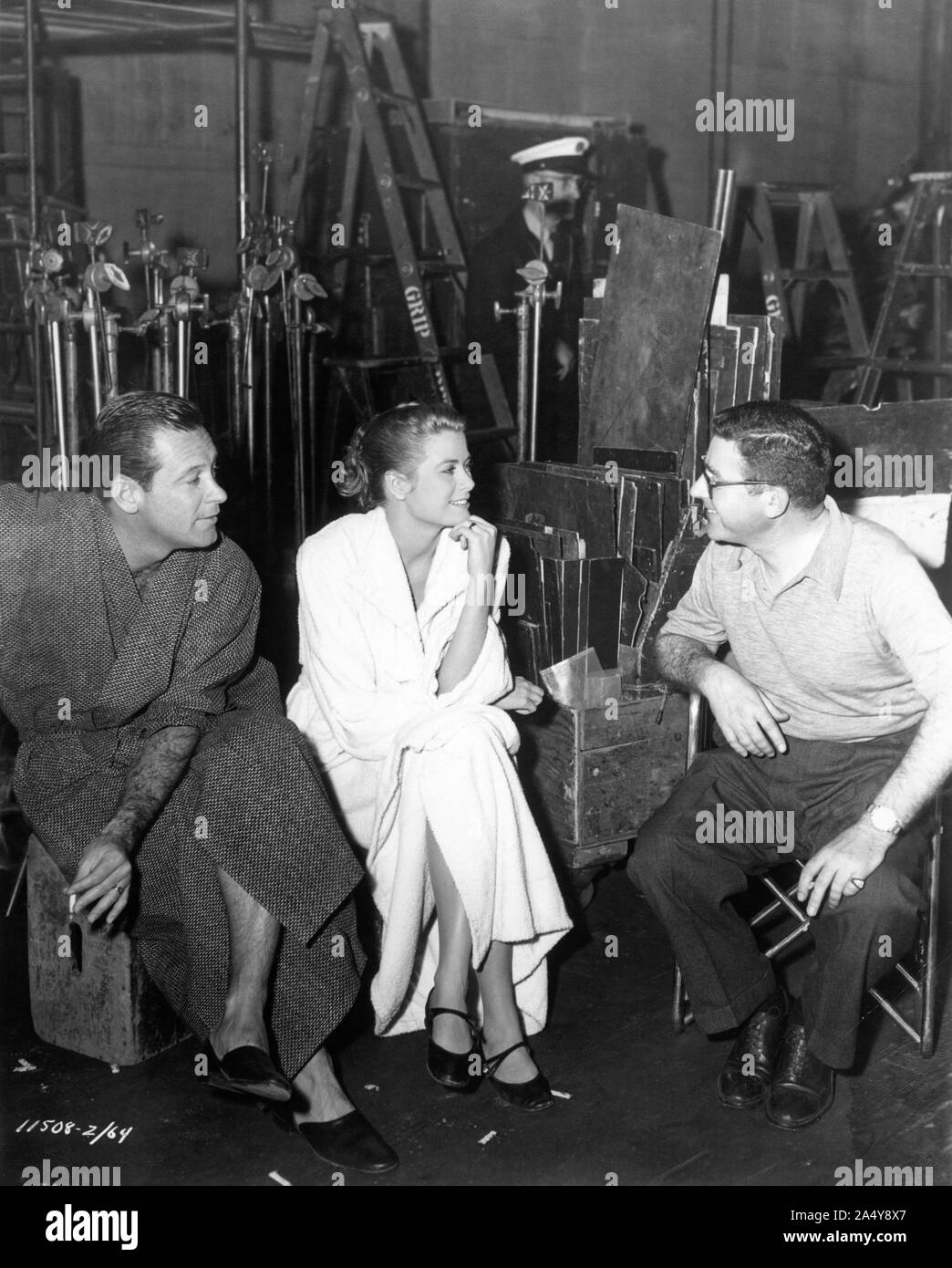 WILLIAM HOLDEN GRACE KELLY and director MARK ROBSON on set candid filming THE BRIDGES AT TOKO - RI 1954 novel James A. Michener Perlberg -Seaton Productions / Paramount Pictures Stock Photo