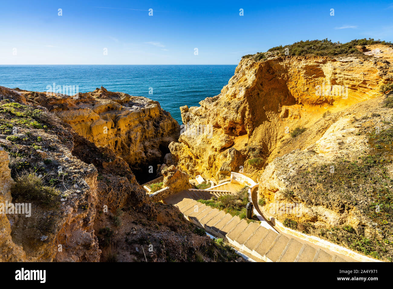 Scenic stairway leading down between the limestone rock of Algar Seco, Carvoeiro, Algarve, Portugal Stock Photo