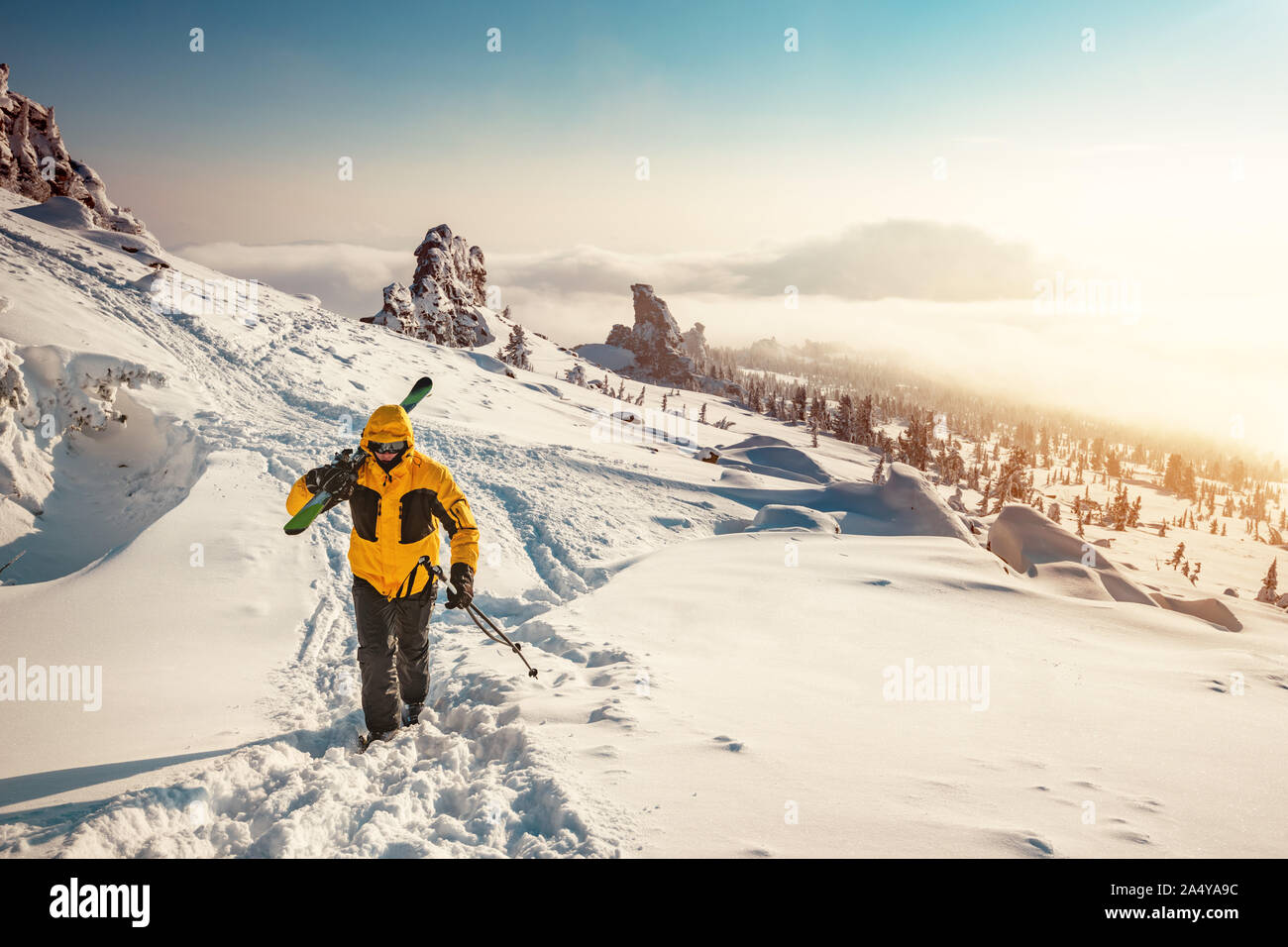 Ski tour concept with skier going uphill for backcountry freeride Stock Photo