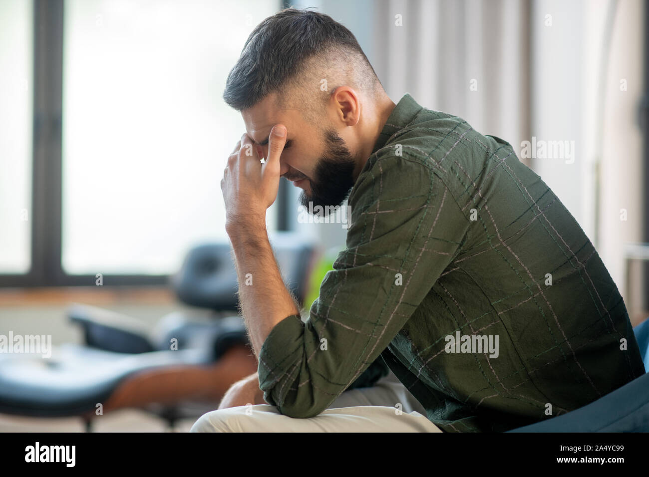 Man sitting near window and waiting for his psychoanalyst Stock Photo