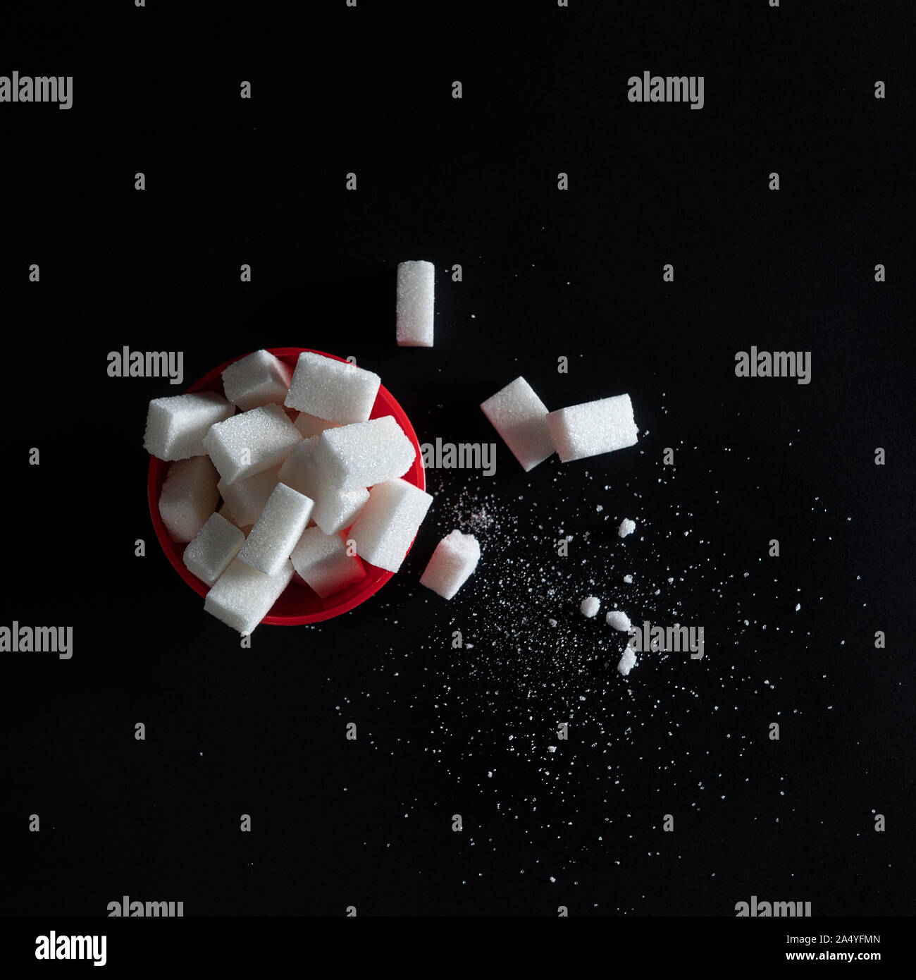 some sugar cubes in a red bowl Stock Photo - Alamy