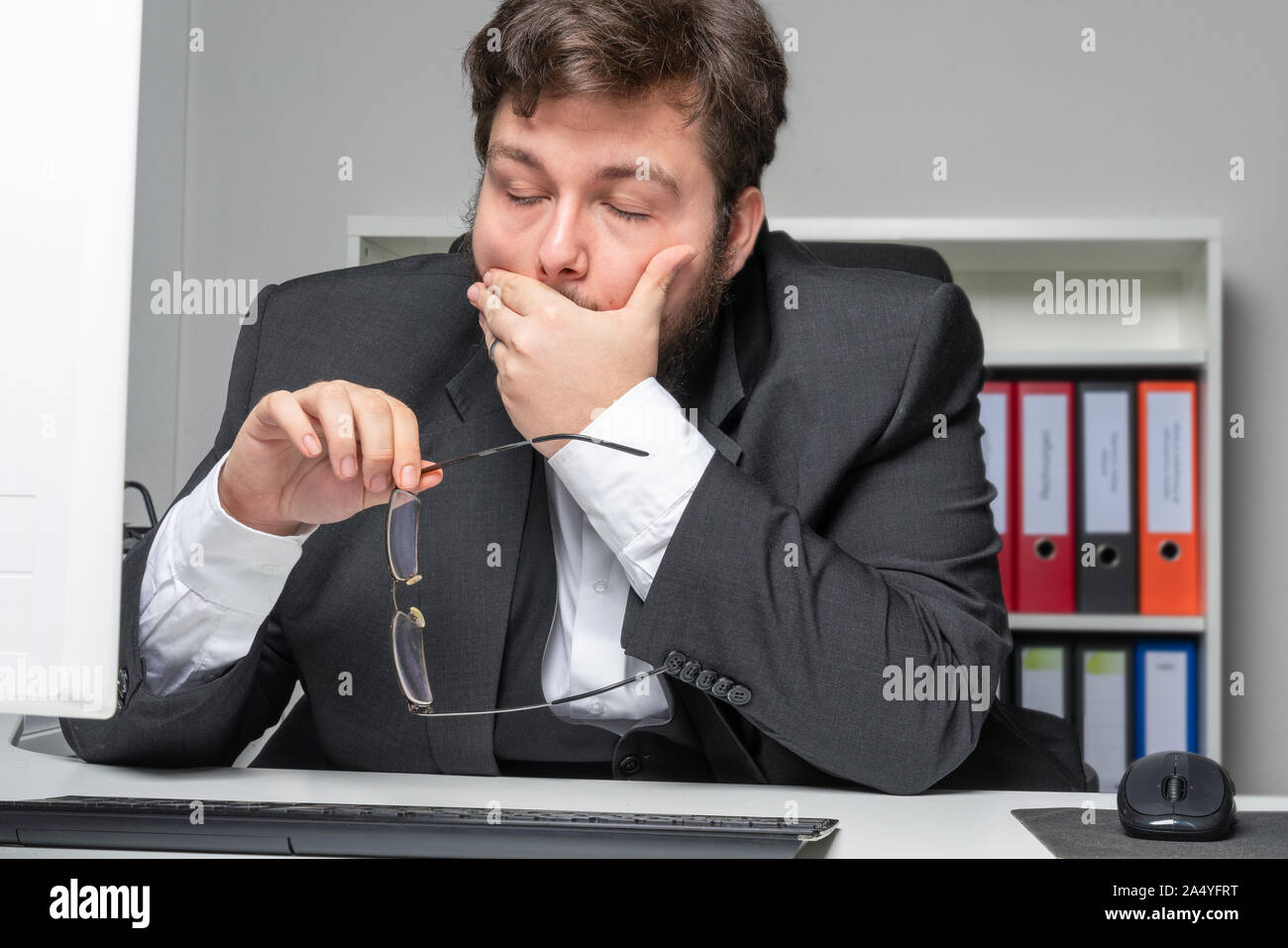 Businessman in the office with headaches leans on the table Stock Photo