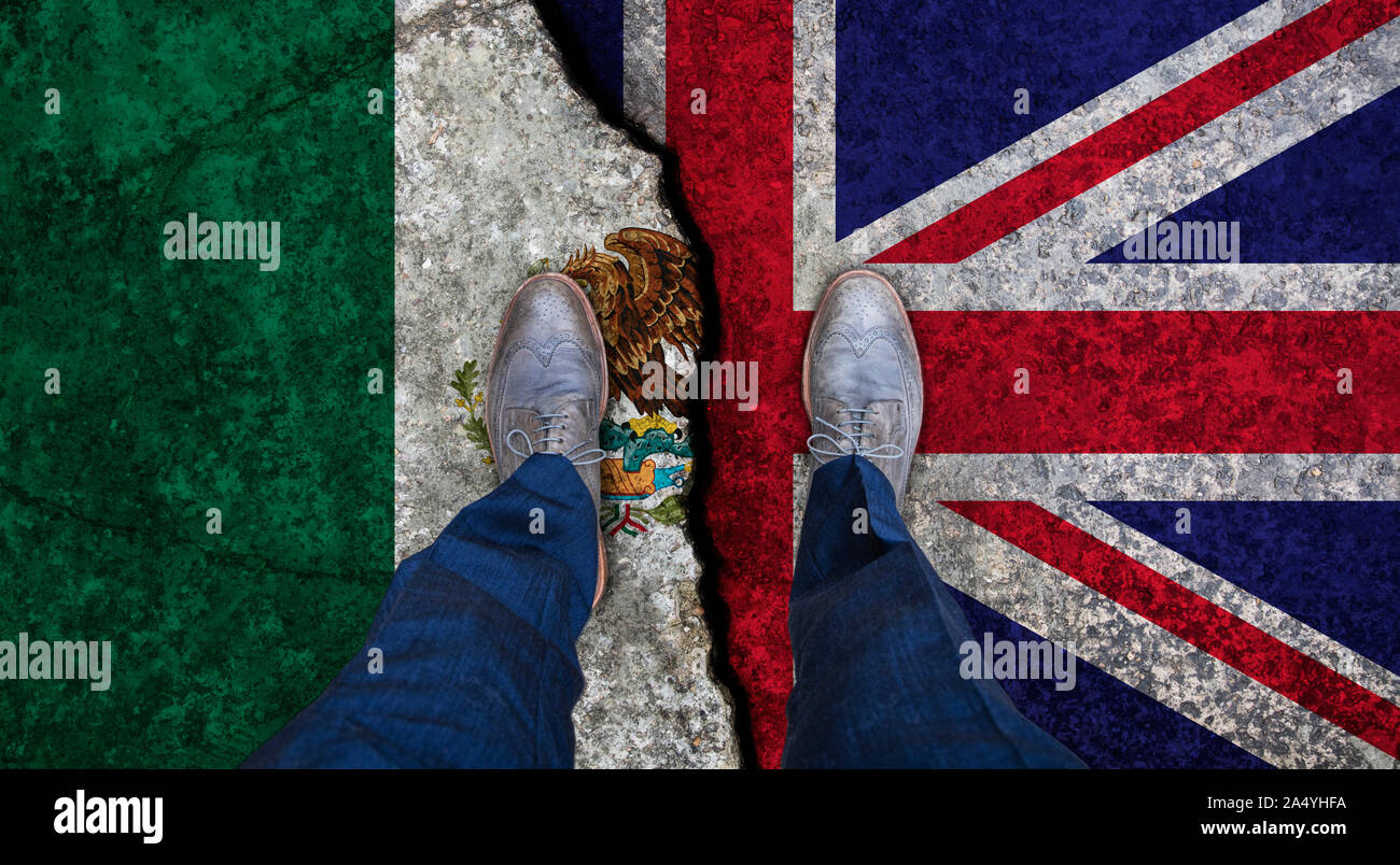Business man stands on cracked flag of UK and Mexico. Political concept Stock Photo