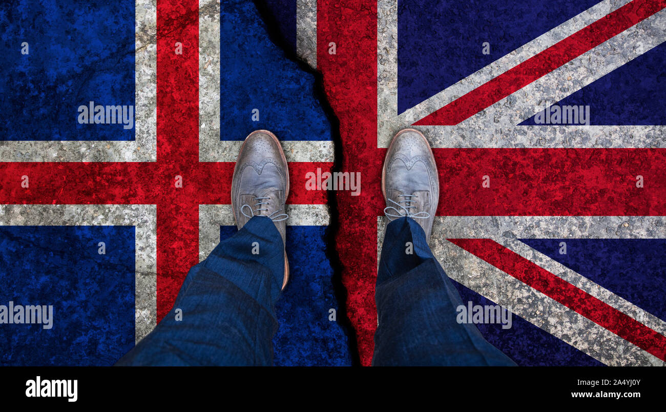 Business man stands on cracked flag of UK and Iceland. Political concept Stock Photo
