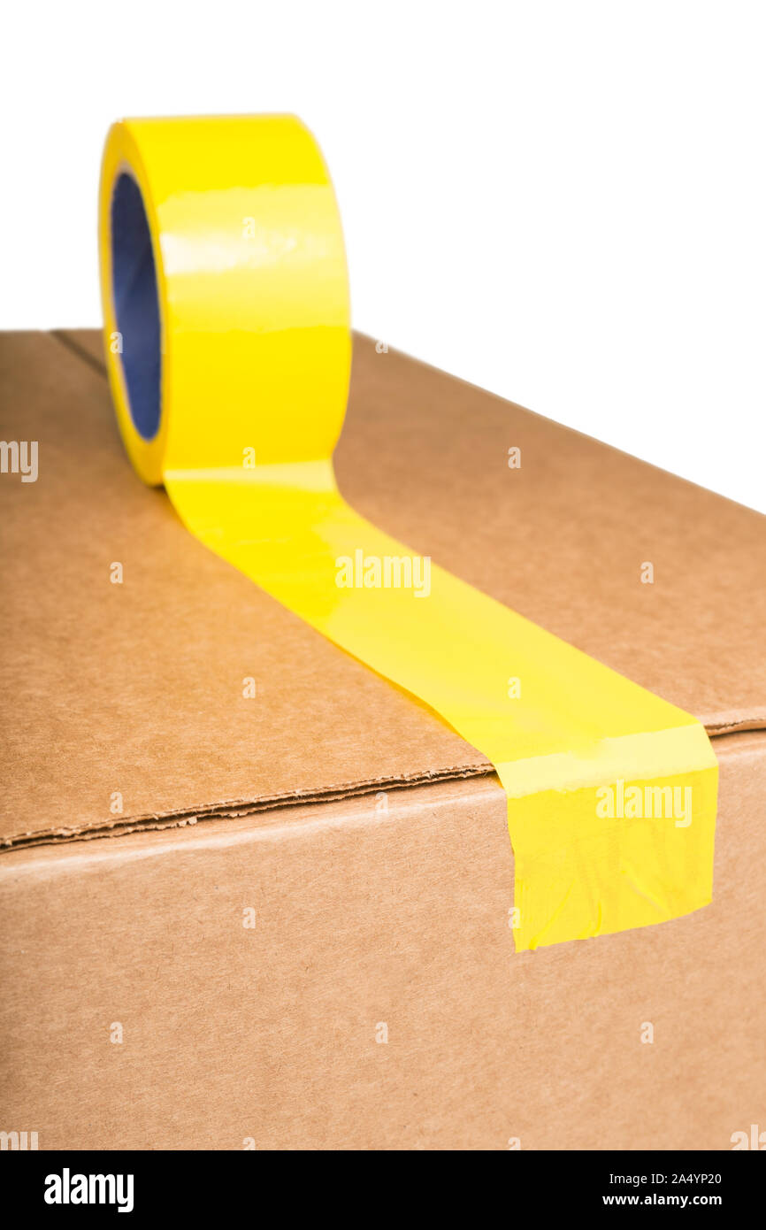 Cardboard box with yellow adhesive tape Stock Photo Alamy