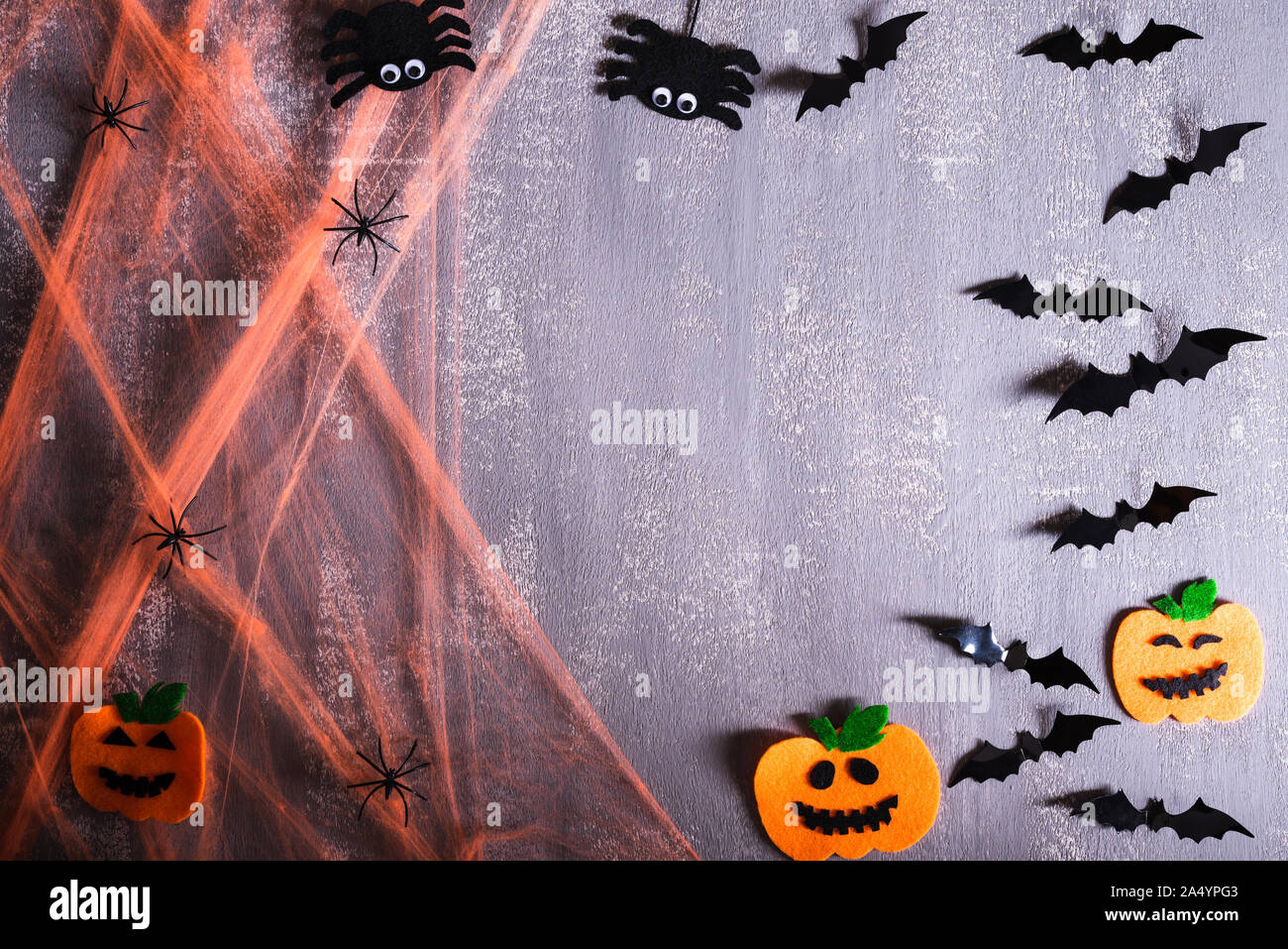 Top view of Halloween crafts, orange Spider web with ghost, bat and ...