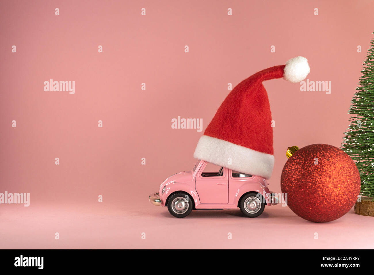 Pink retro toy model car with small red 
