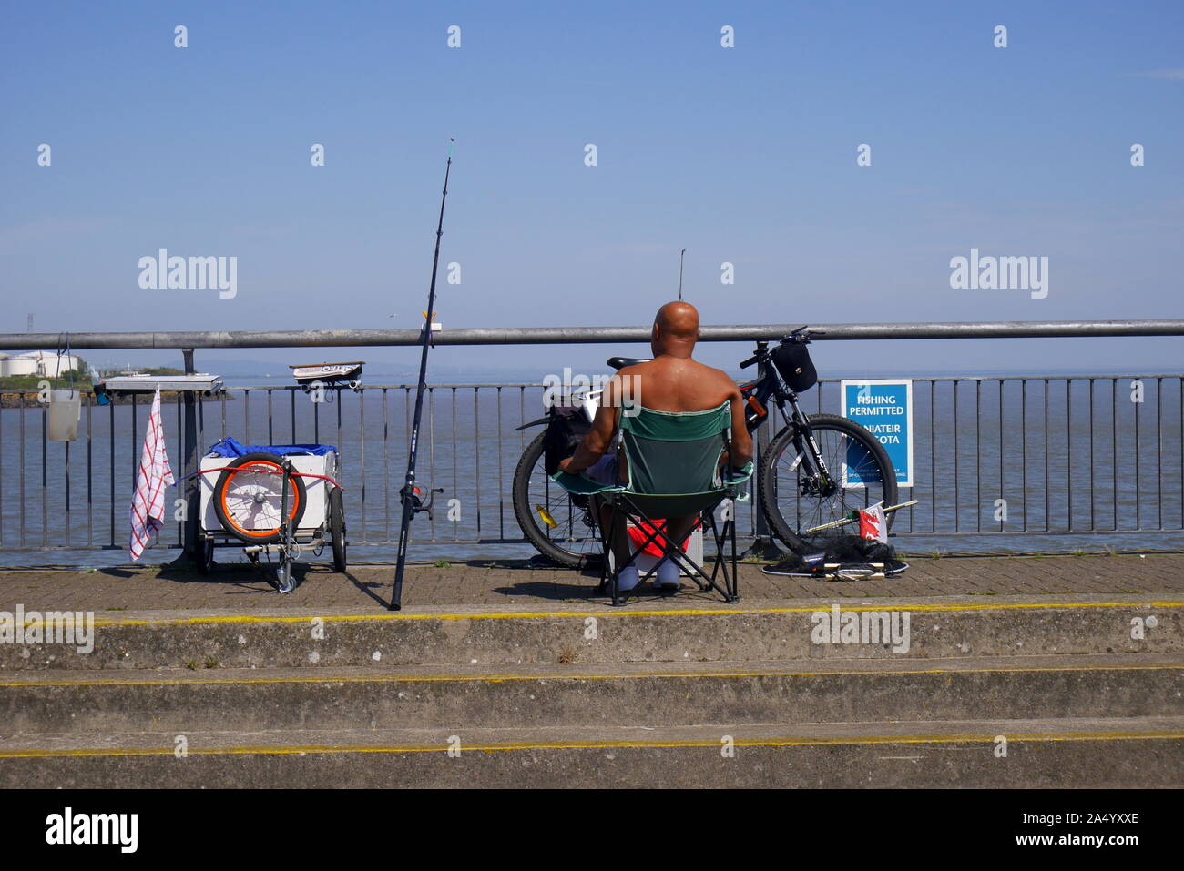 Man fishing, Cardiff Bay Barrage, Cardiff Bay, Cardiff, South Wales, United Kingdom Stock Photo