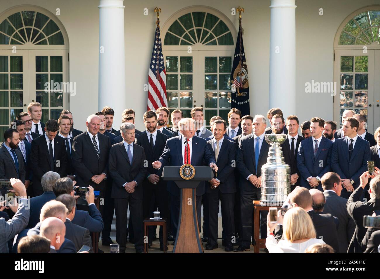 U.S President Donald Trump, center, during a ceremony welcoming the 2019 Stanley Cup Championship professional ice hockey team, the St. Louis Blues, in the Rose Garden of the White House October 15, 2019 in Washington, DC. Stock Photo