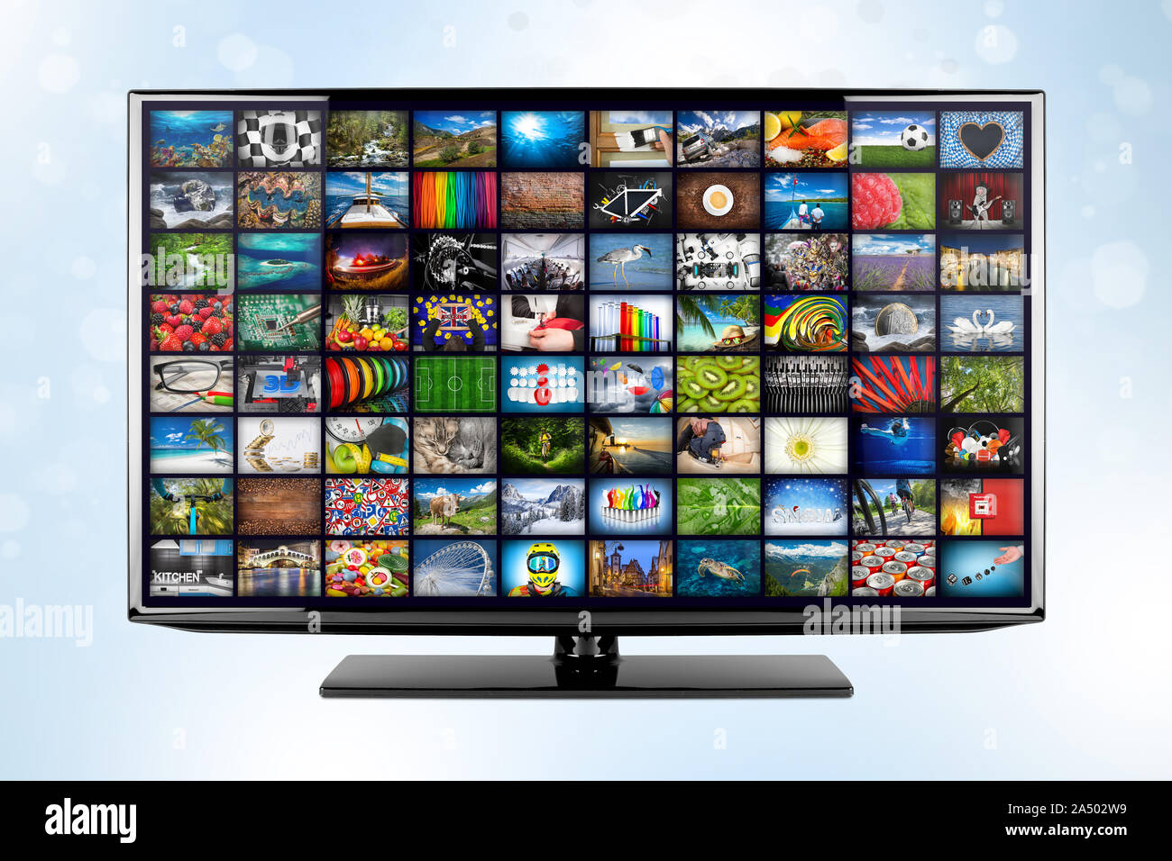 black flat tv screen monitor display with picture movie gallery backdrop. television in front of blue white bokeh background. Computer multimedia stre Stock Photo