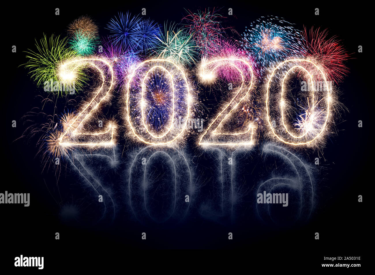 colorful fireworks display and bright sparkler pyrotechnic number 2020 2019 change happy new year sylvester concept on black blue background Stock Photo