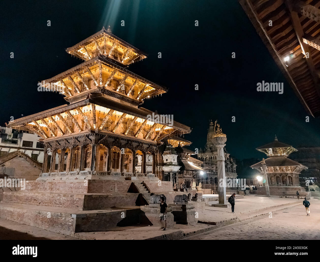 People walking around Patan Durbar Square, a UNESCO Heritage site in Nepal. Stock Photo