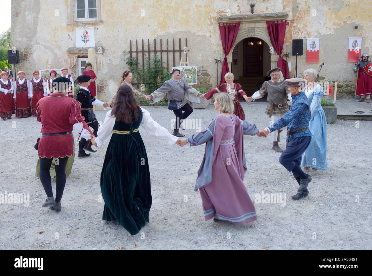 Circle folk dance performs by Re-enactment group in Tabor mansion's courtyard. Vojnik. Slovenia. Stock Photo