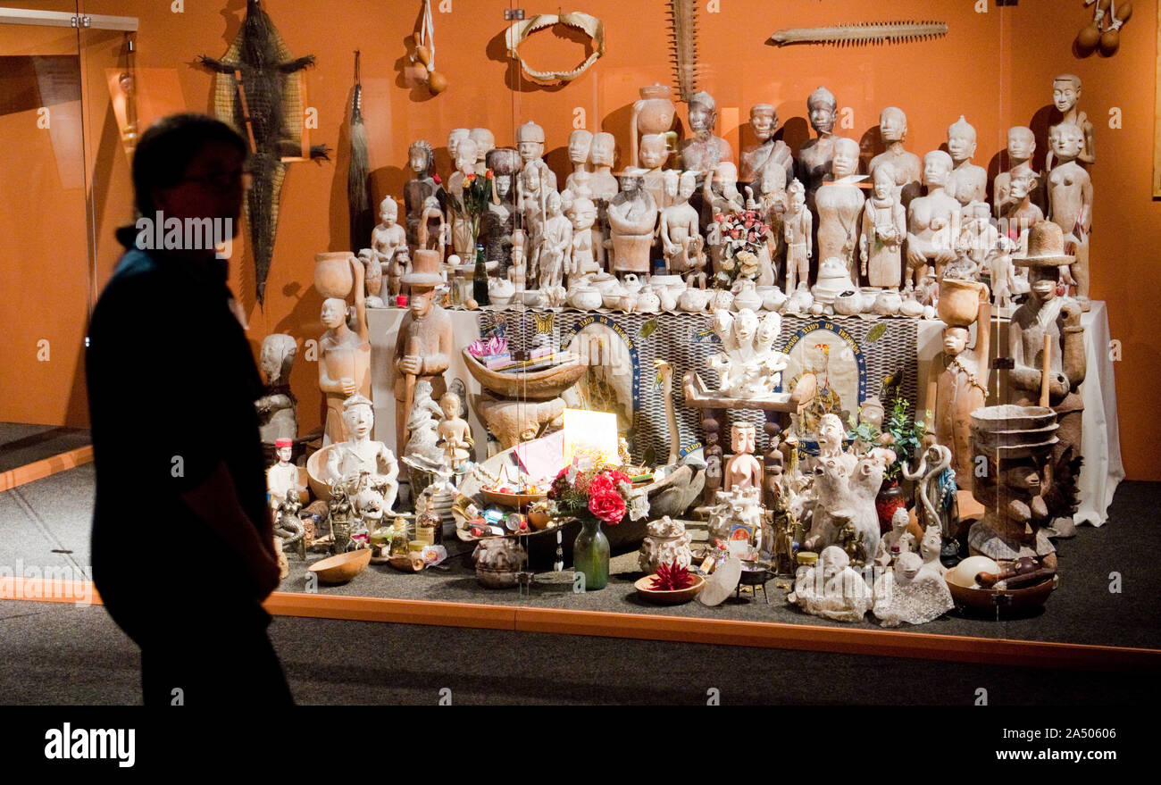 Hildesheim, Germany. 17th Oct, 2019. A woman stands at the Mami Wata altar in the special exhibition 'Voodoo' in the Roemer and Pelizaeus Museum. The exhibition from 19.10.2019 to 17.05.2020 shows about 1200 objects around the Voodoo religions. Credit: Julian Stratenschulte/dpa/Alamy Live News Stock Photo