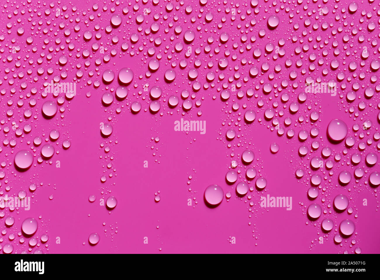 Macro image of water drops on pink surface Stock Photo - Alamy