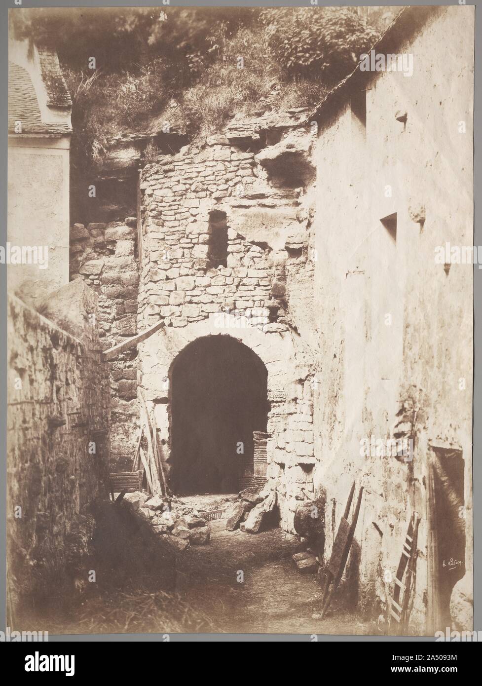 Behind the Troglodyte Farm, c. 1853. Trained as a painter, Le Secq was drawn to the new invention of photography in the late 1840s. He became one of the most gifted early photographers to record architecture and sculpture before his brief, illustrious career ended in 1856. Only one of two known prints, this large-scale image, exceptional for the period and process, belongs to a small group of photographs of troglodyte dwellings in western France near the Loire River. In the mid 19th century, artists of all media were attracted to rustic domestic scenes for both their picturesque qualities and Stock Photo