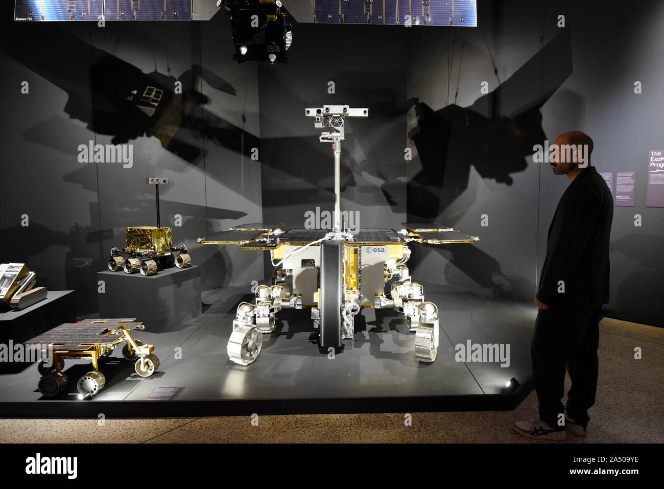 London, UK.  17 October 2019. A staff member views the ExoMars Rosalind Franklin rover from the European Space Agency.  Preview of 'Moving to Mars' at the Design Museum. The exhibition explores how sending humans to Mars is a frontier for science as well as design and features over 200 exhibits from NASA, the European Space Agency together with new commissions.  The show is open 18 October to 23 February 2020.  Credit: Stephen Chung / Alamy Live News Stock Photo