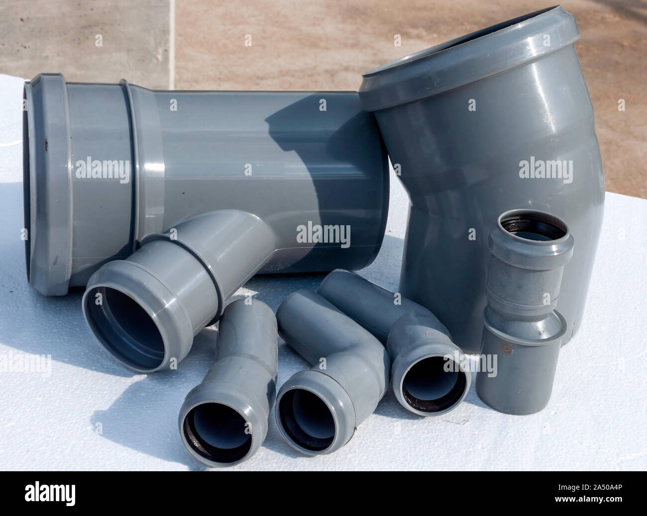Composition from plastic sewer pipes, isolated on a white Stock Photo