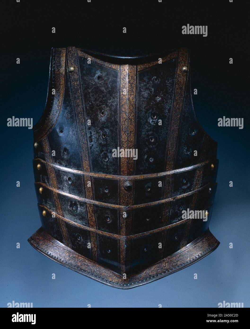 Breastplate from Hussar's Cuirass, c. 1580. This style of breastplate, with its numerous articulating lames, was probably used by a Hungarian hussar, a type of light cavalryman. The steel plates were originally blued-now turned russet-and etched and gilded with strapwork bands. The rows of vertical holes once provided gilt-brass settings for stones or glasspaste jewels. The effect would have suggested the semi-oriental costume and armor of the Near East favored by Polish and Hungarian armies of the late Renaissance. Stock Photo