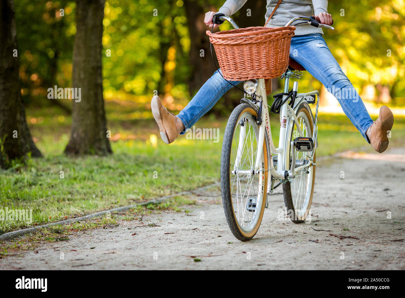 Woman riding bicycle with her legs in the air Stock Photo - Alamy