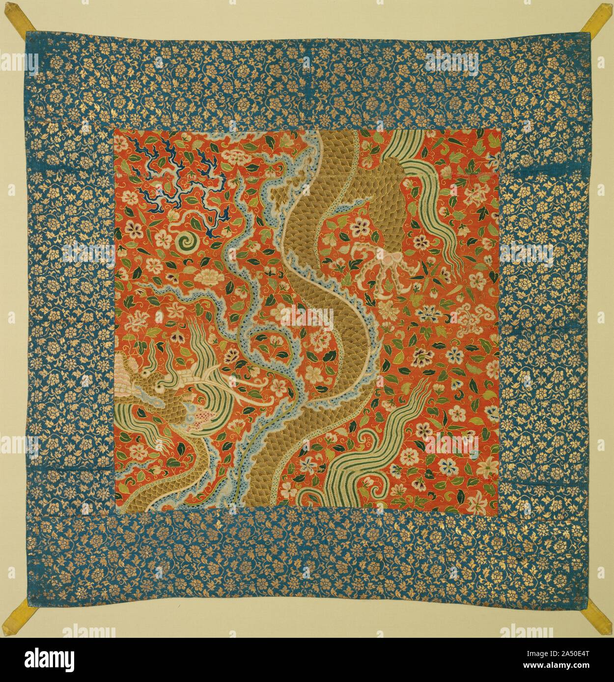 Canopy with Dragon Among Flowers, late 1100s. This rare silk tapestry in the center, from the Southern Song imperial workshop in Hangzhou, incorporates Central Asian and Chinese influence. The golden dragon on a ground of flowers is Central Asian, as are the dragon&#x2019;s upturned snout, flaming mane, and antlers. The serpent-like treatment of the dragon&#x2019;s body, however, is Chinese in style. The fineness of the silk threads, weaving, and flat gold thread gilded on both sides indicates imperial production. The tapestry was sewn at an unknown time to a later Ming dynasty border with tab Stock Photo