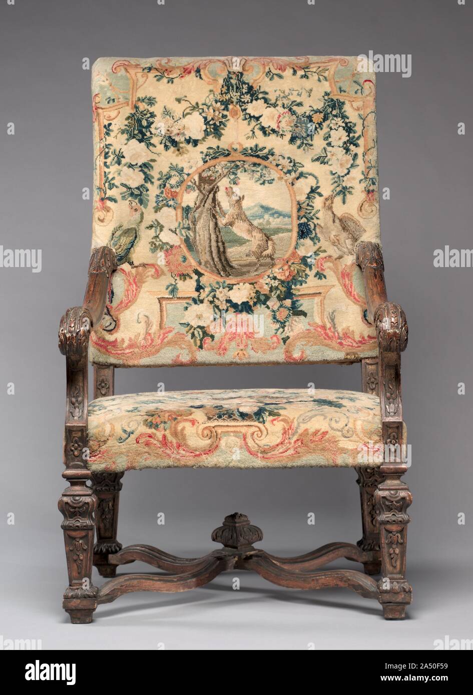 Chair, before 1717. These chairs belong to a suite that includes a settee (also in the CMA&#x2019;s collection) and a tapestry made for a count and countess to mark their wedding in 1717. Furniture of this scale was usually placed against the wall in grand reception halls, more as a display of wealth than for use. Upholstered in Savonnerie tapestries, this suite was among the most treasured and expensive example anyone could own and typically reserved for royalty.    To add decorative and intellectual interest to the textiles, weavers incorporated symbols depicting various stories from the  Fa Stock Photo