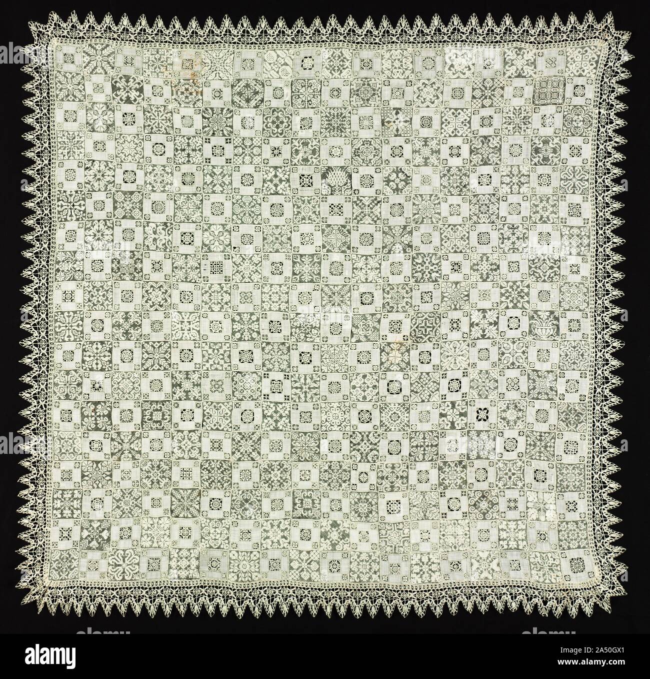Cloth with Floral and Vegetal Patterns, 1560-1600. The artistic creativity and technical fineness achieved by expert needlewomen are illustrated by this spectacular cover with richly varied needle lace and cutwork decoration with a bobbin lace border. Around 1600, needle and bobbin lace began to serve similar decorative purposes, although they developed from different sources. Needle lace used in cutwork grew out of white embroidery while bobbin lace was closely linked to braiding. Stock Photo