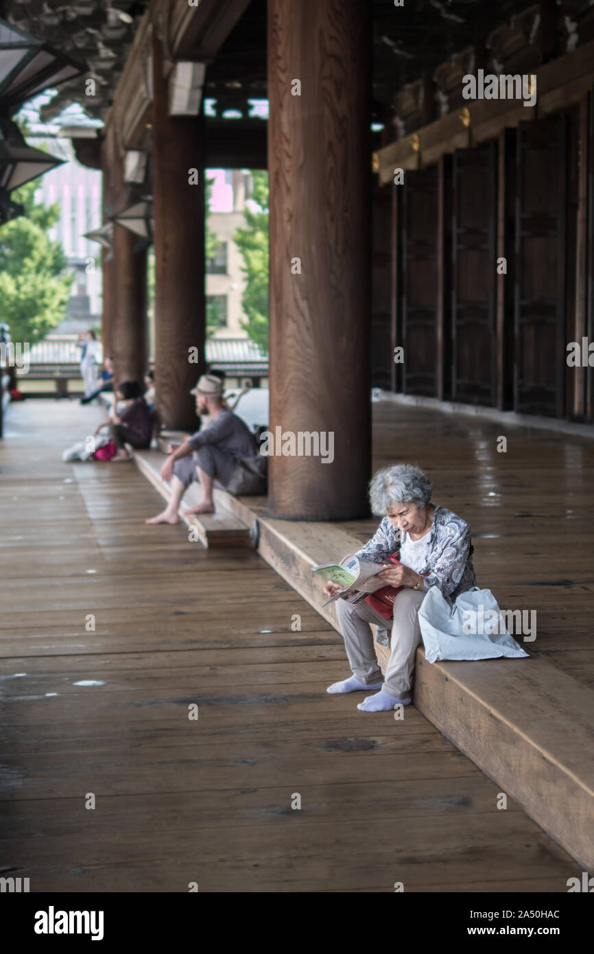 Old asian women reading kyoto temple introduction pamphlet . Healthy grand ma visiting alone japanese city, Kyoto, Japan, 29-7-19 Stock Photo