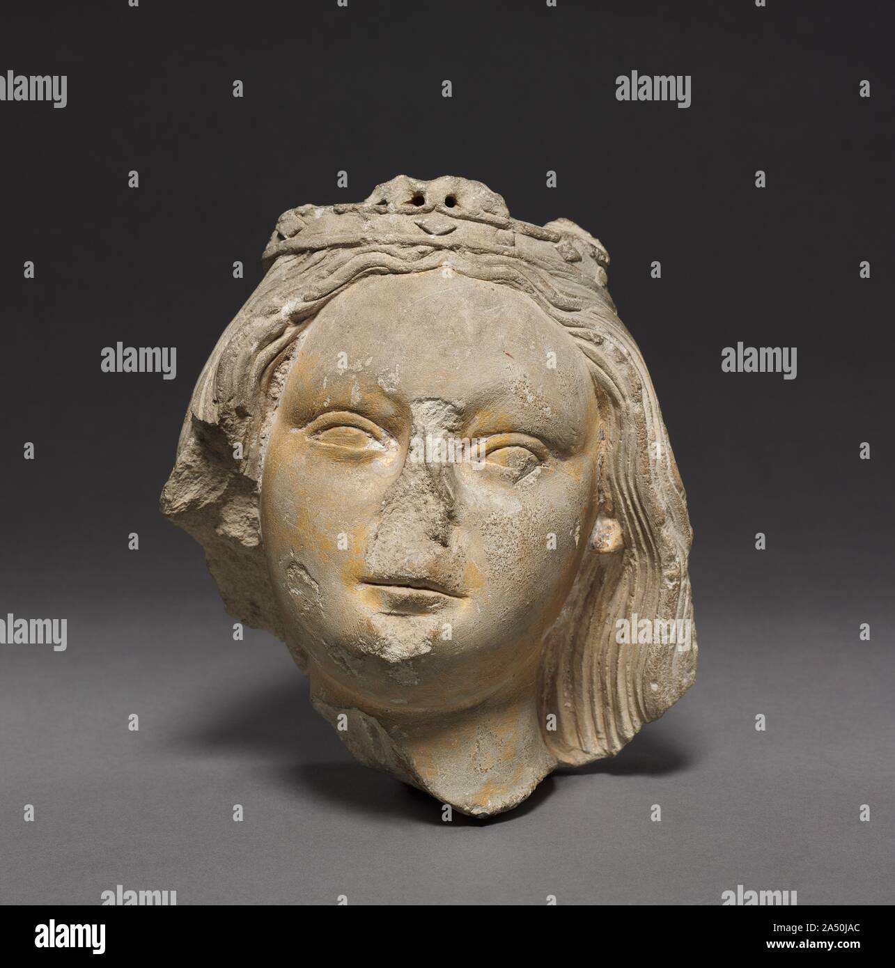 Crowned Female Head (Fragment), c. 1400-1420. The origins of this sculptural fragment are not known. It is perhaps the final trace of the once beautiful figure of a standing Virgin and Child. Stock Photo